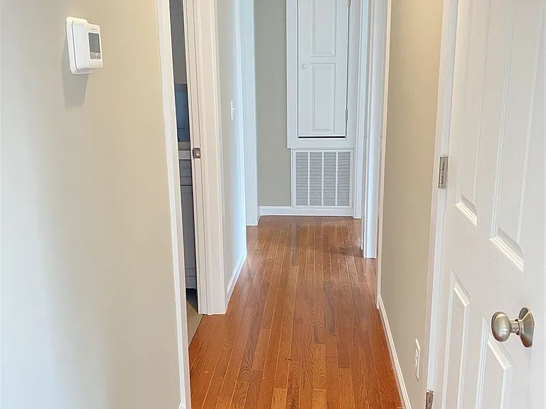 Hallway to bedrooms, with large coat closet and small linen closet