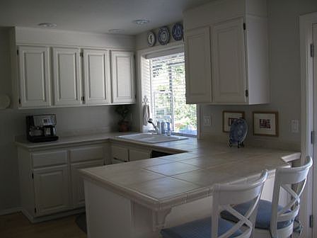 Kitchen with eating nook, French doors, maple hardwoods, and beadboard accents