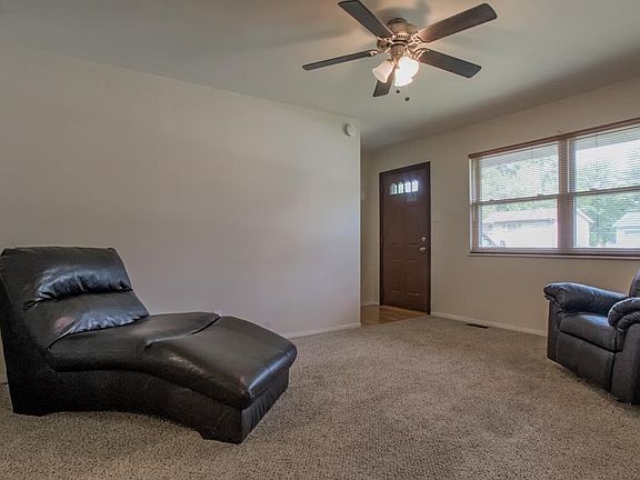 Living room with newer carpet on Main level of the home.