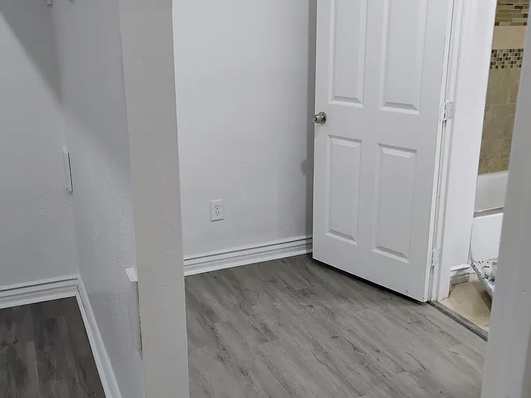 Right side of Master bedroom closet with a closet entrance to Master bathroom. It also has a Master bedroom entrance. Master bathroom has a tub/shower combination, with a sink and toilet.