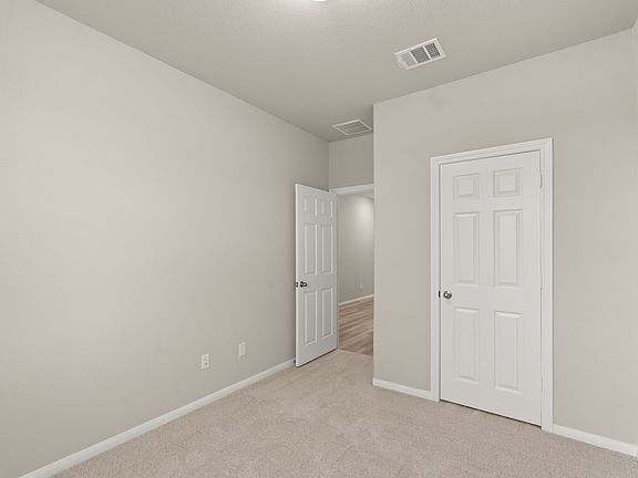 An additional view of the secondary bedroom and closet