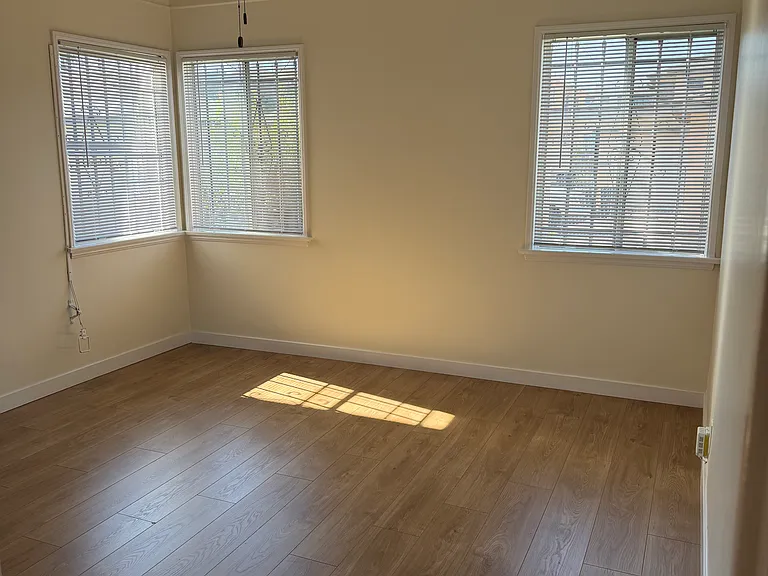 West bedroom with ceiling fan.