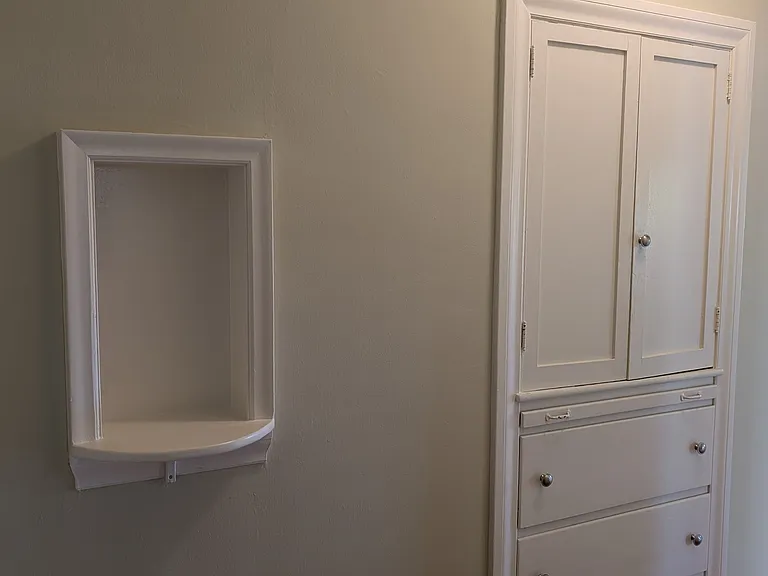Original architectural details like this telephone niche and large linen closet