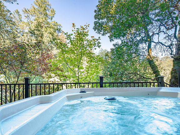 Soak in a hot tub, with breathtaking views of nature from your private deck.