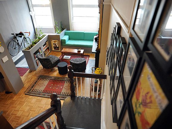 This is the living room. It has a built in teal sofa.