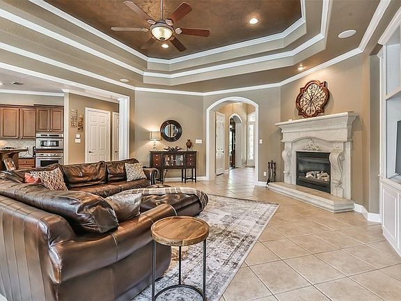 Great room surrounds a fireplace and provides easy access to the kitchen and breakfast room.