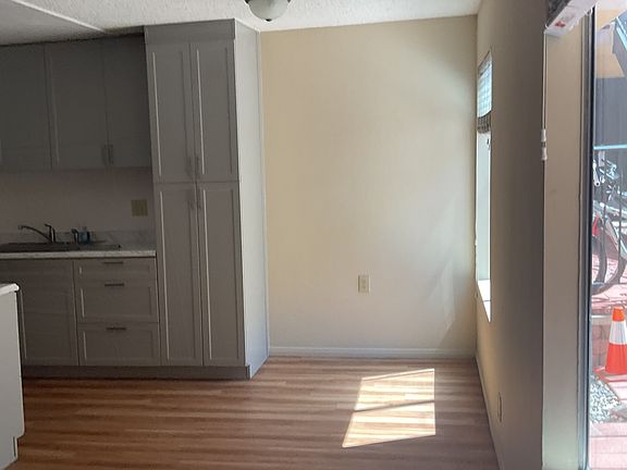 View of dining nook from entryway.
Ample windows with large blinds look onto shared courtyard.