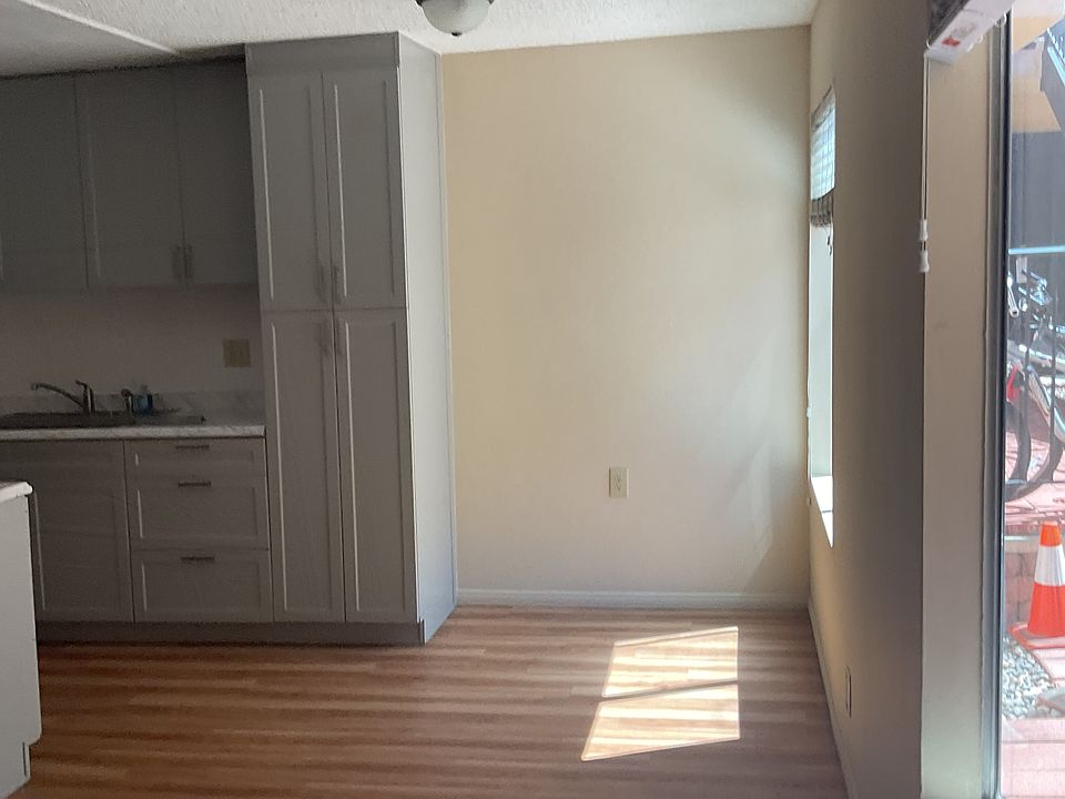 View of dining nook from entryway.
Ample windows with large blinds look onto shared courtyard.