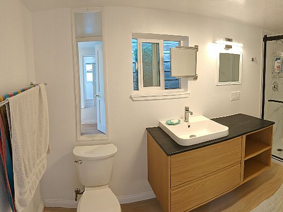 Bathroom includes ceiling heater, humidity sensing vent fan, and USB charger outlets.