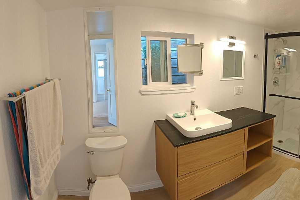 Bathroom includes ceiling heater, humidity sensing vent fan, and USB charger outlets.