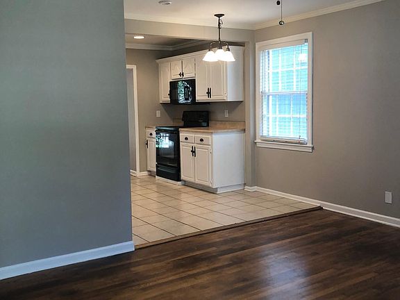 Living room open to kitchen with intimate eat in kitchen whi