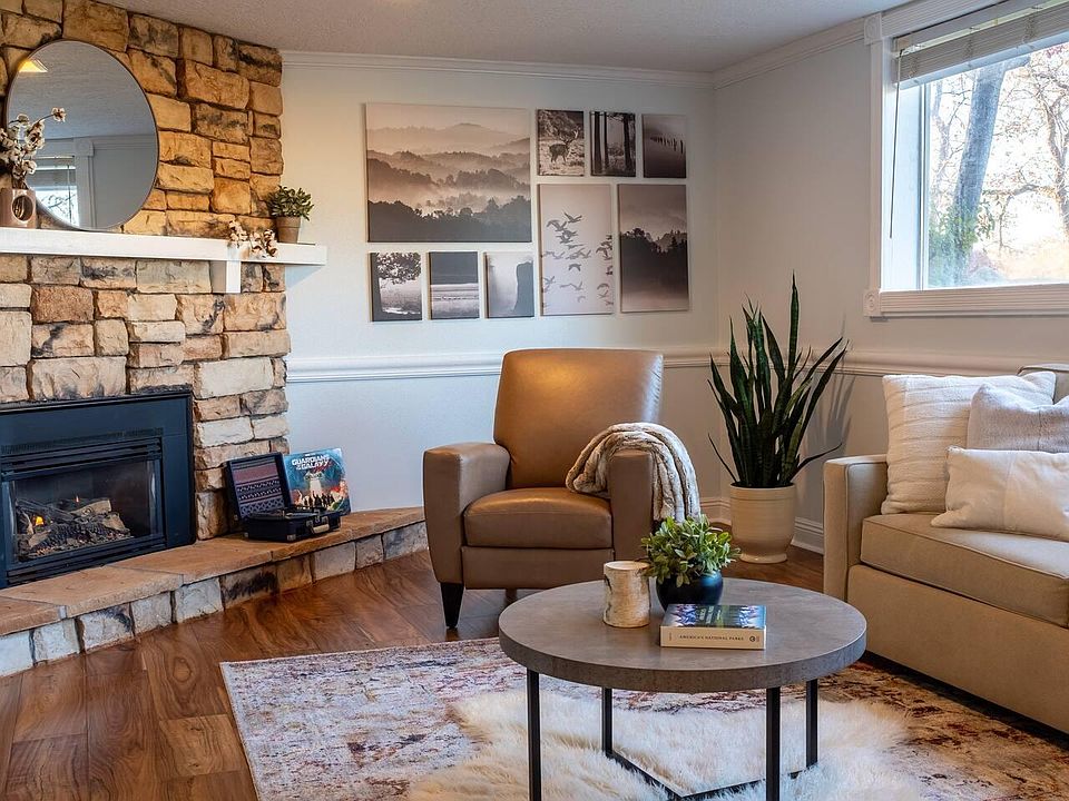 Living room with pull out couch and 2 recliners. Working fireplace.