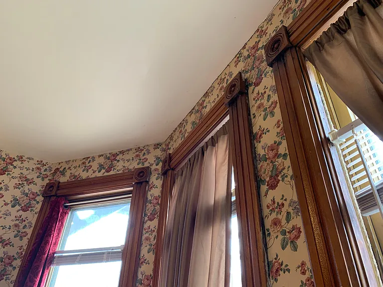 Tall Victorian windows with woodwork