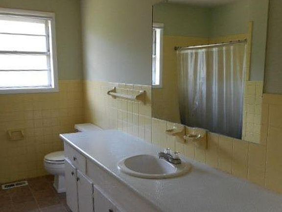Full bath with tile floors and counters