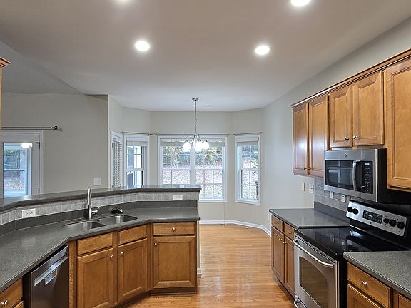 Beautiful open kitchen with SS appliances and breakfast area