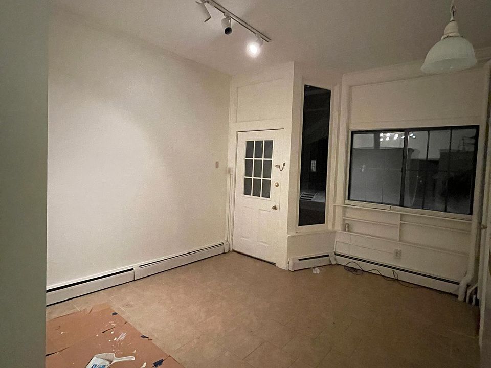 Living room with high ceiling and ceramic tile.