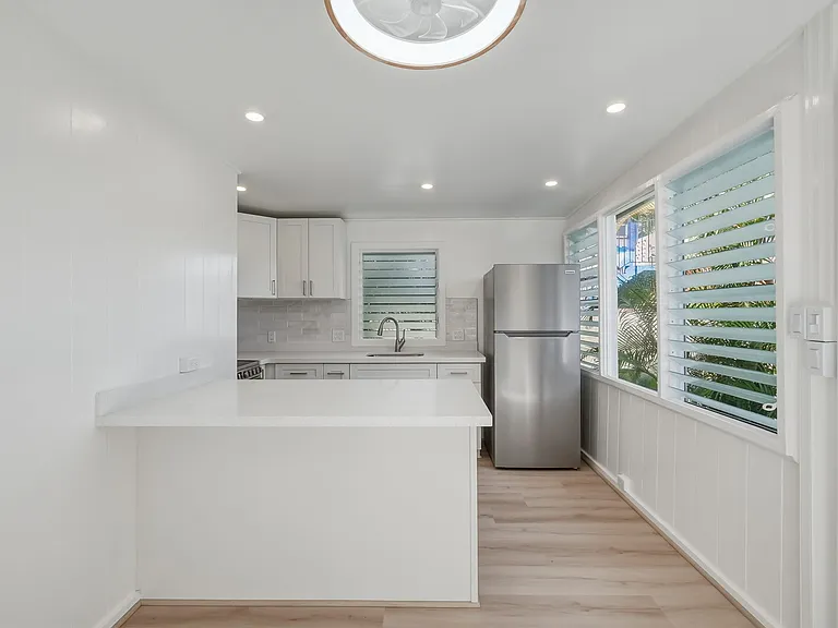 Completely remodeled with new kitchen, appliances, lighting, ceiling fan and flooring.