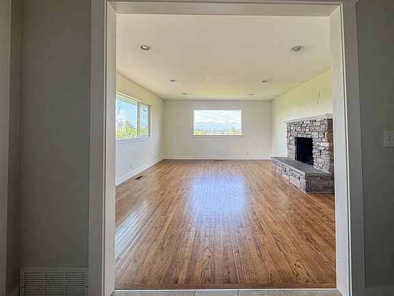 Livingroom with working fireplace. Windows facing south and west. Views of Olympic Mountains. Electrical mounts for cable tv on mantle.

19ft x 14ft