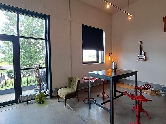 Extra high ceilings and natural light make this living space/dining area perfect for entertaining.