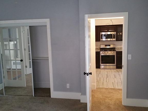 Bedroom looking to kitchen. Bathroom off the right.