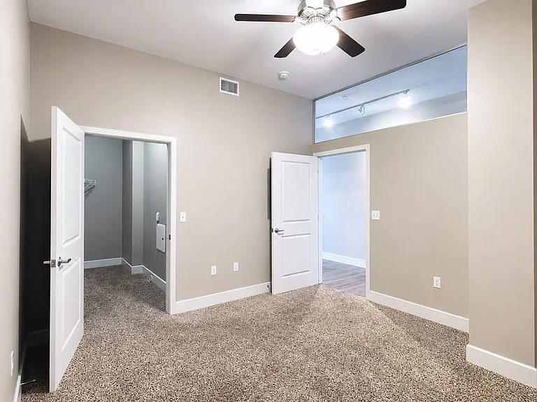 Step into the elegance of Heer's Luxury Living, where spacious interiors meet modern design. This stunning room features plush carpeting and abundant natural light, perfect for creating your ideal sanctuary. Schedule your tour today!