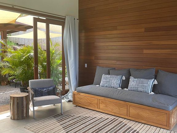 Den and entertainment room Which opens to the garden on both sides with 14 ft doors.