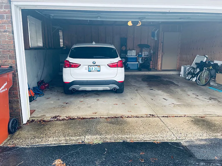 garage with elec opener and one stall for our condo and lots of storage in front of the vehicle as well as a doorway exiting to covered walkway.