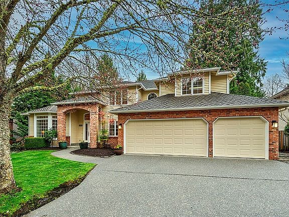 Large expansive driveway with 3 car garage