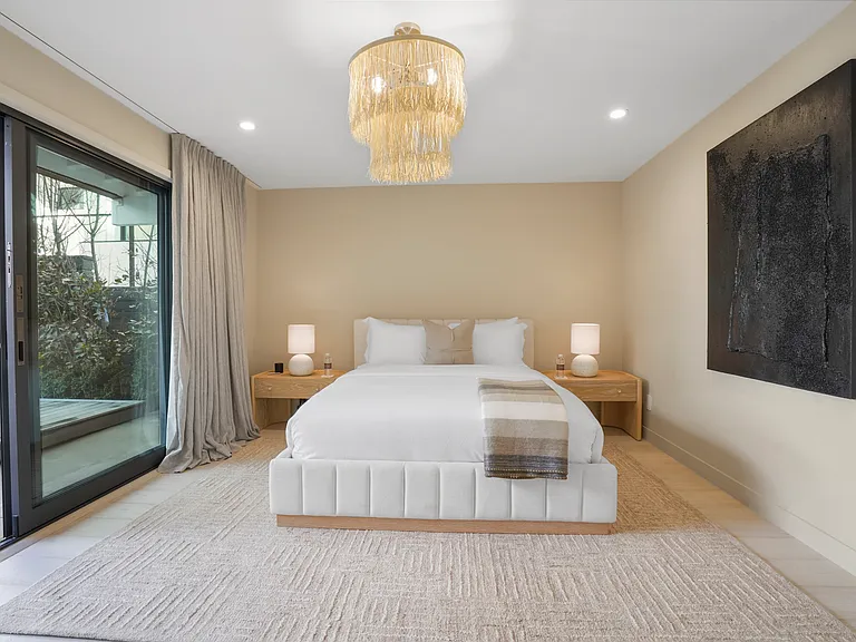 Unwind in a serene retreat, complete with soft textures and warm lighting.