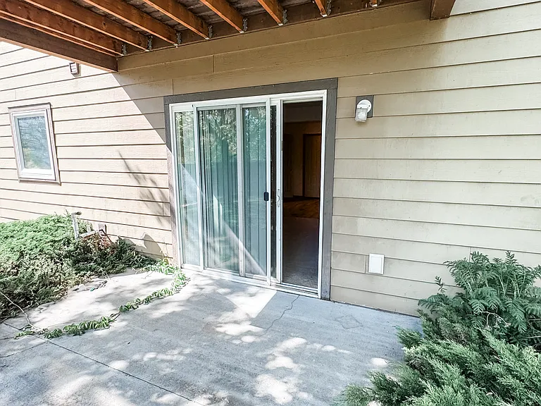 Back door to gated common yard. Back of the fence is on the riverbank