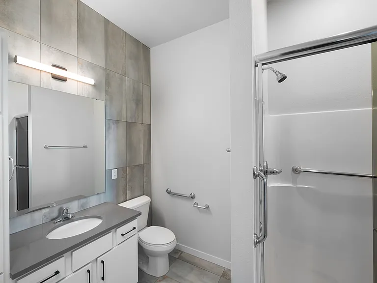 Modern bathroom featuring sleek countertops, contemporary lighting, and a glass-enclosed shower for a luxurious touch. Modern bathroom featuring sleek countertops, contemporary lighting, and a glass-enclosed shower for a luxurious touch.