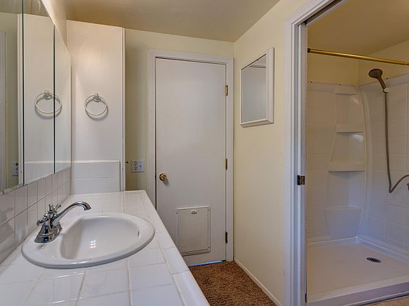 Bathroom showing shower toilet room. Vanity outside. Very handy if two people are getting ready at the same time.