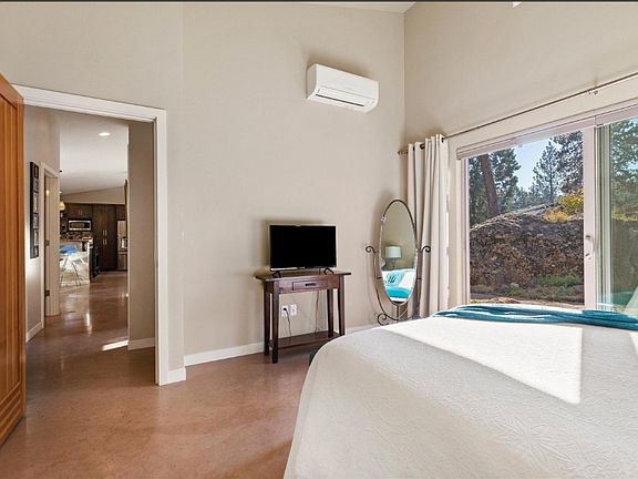 The main bedroom with its view of the rock and (seasonal) waterfall into a small garden pond.