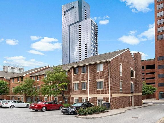 Back of condo with gated parking lot.