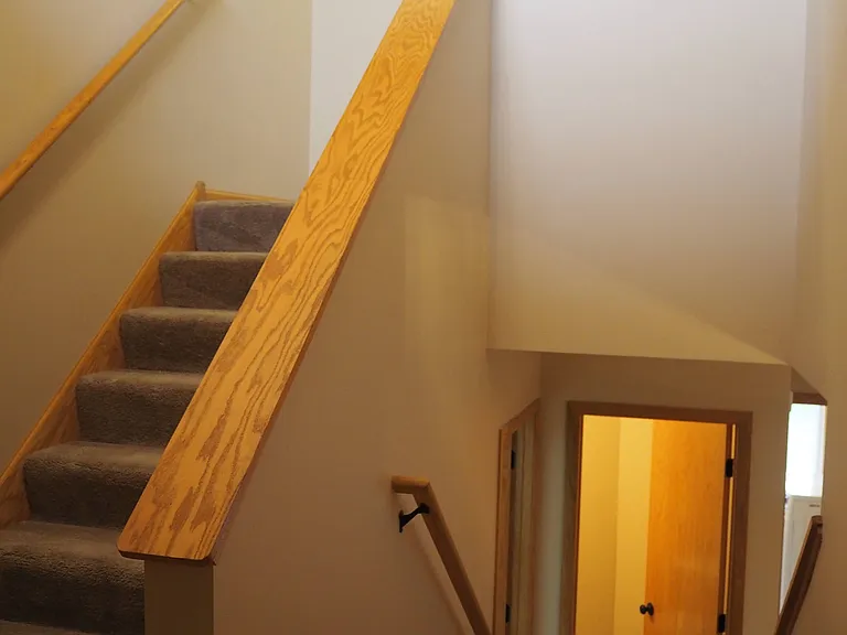 Entry with door from garage and coat closet. Go up for bedrooms or down for living areas.