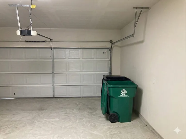 Two car garage with automatic door opener.