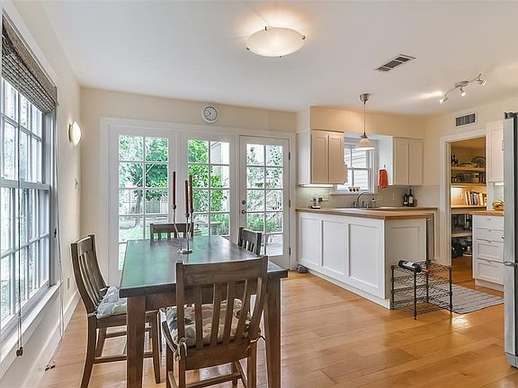 Bright dining and kitchen opens to patio with mature fruit trees