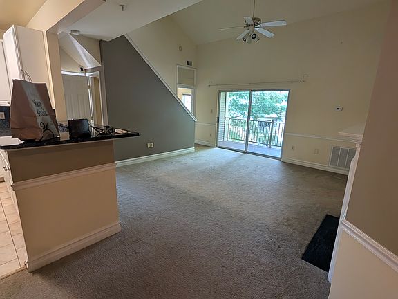 Spacious living area with double-height ceilings and access to to the patio