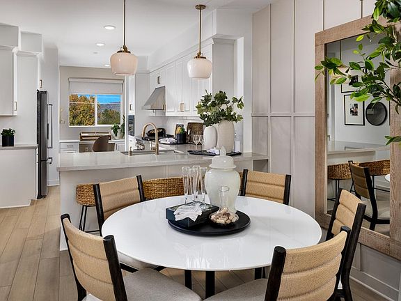 A photo of the Dining with a view of the Kitchen in the Plan 1 model home at Magnolia in Arcadia.