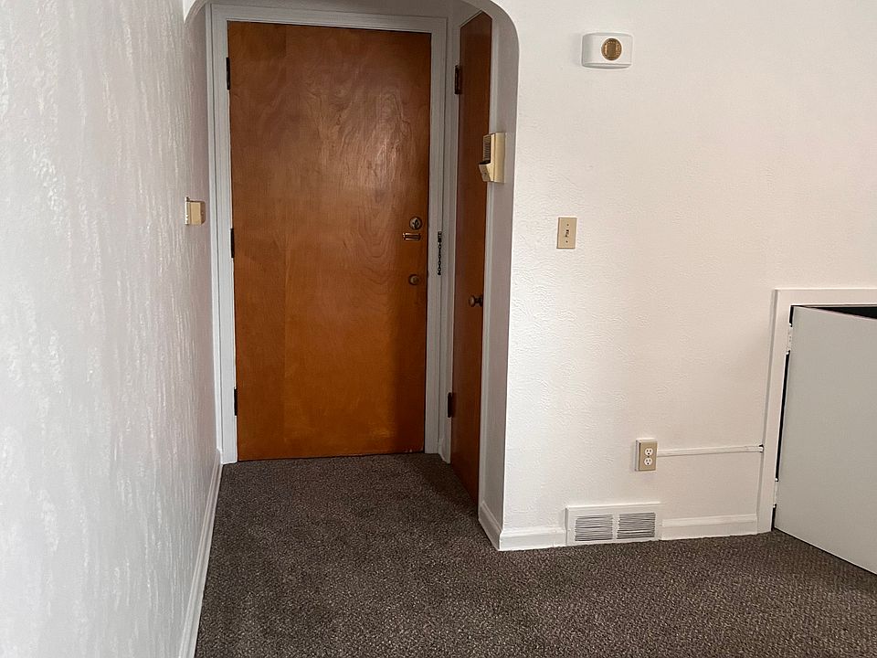 Front door to the front hallway and coat closet