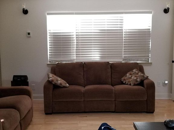 Living room area. Storage closet with shelving.