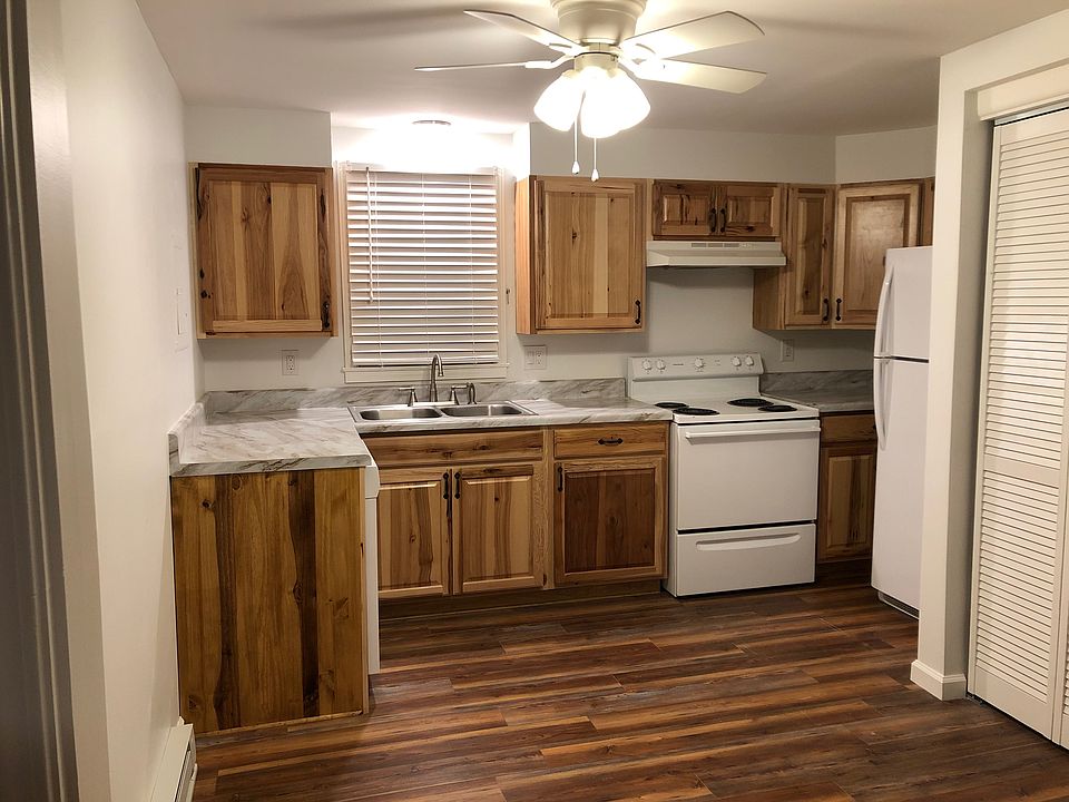 Kitchen, with dishwasher on left at the end of the "L" shape. Washer and dryer behind louvered doors.