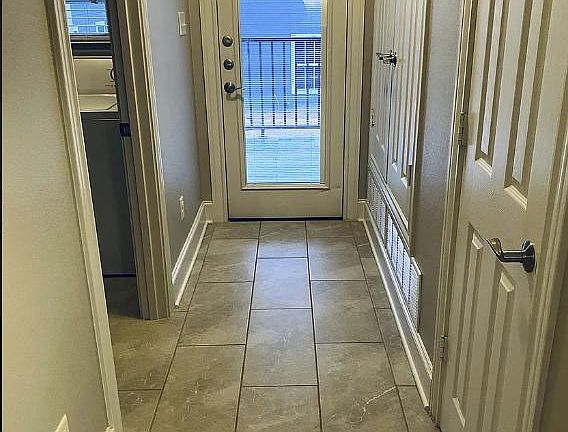 Hallway to private balcony #1, pantry and laundry room