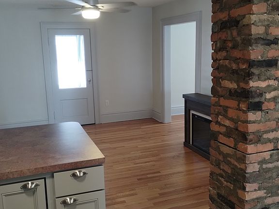 View from the kitchen. Door leads to a enclosed porch. Overhead fans with remotes in the living room and the bedroom.