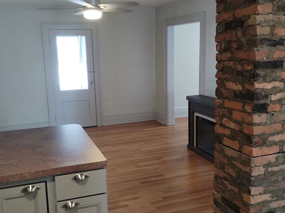 View from the kitchen. Door leads to a enclosed porch. Overhead fans with remotes in the living room and the bedroom.