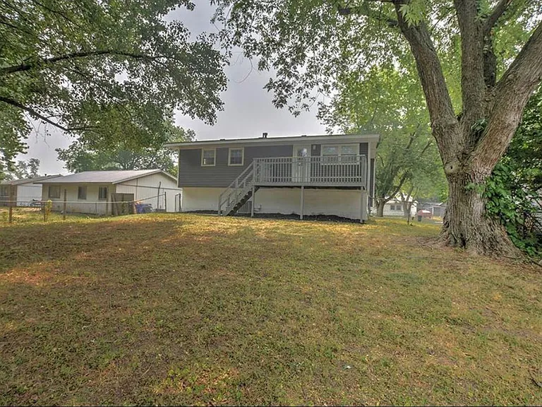 Fenced backyard with deck