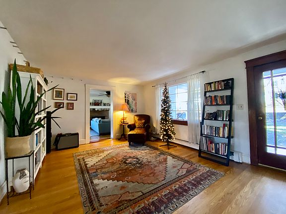 The front room features large windows and a beautiful picture window door.