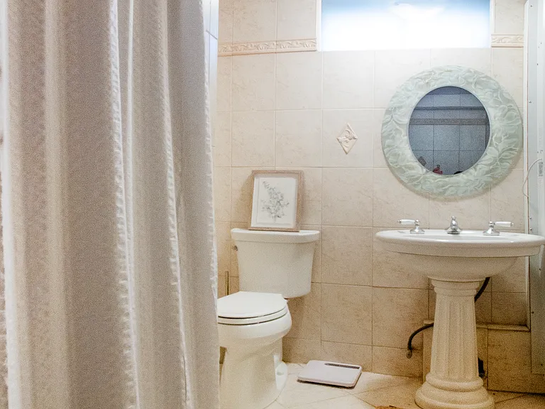 Full bathroom with shower and linen closet.