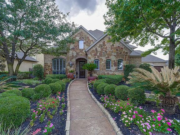 STAMPED CONCRETE WALKWAY, STONE CURBING AND LANDSCAPE ACCENTS. LOW VOLT LIGHTING, SPRINKLER SYSTEM, SHUTTERS ON WINDOWS. FIELD STONE AND STONE BRICK ELEVATION.