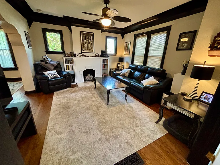 Shared living room with seating, fireplace, TV